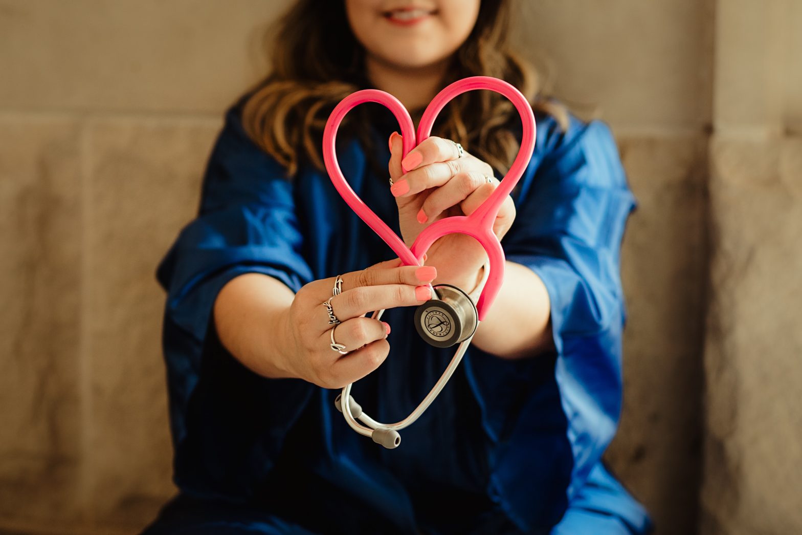 A woman holding a stethoscope in a heart shape illustrating a Heart to Heart on Health and Why Health Equity is Vital.
